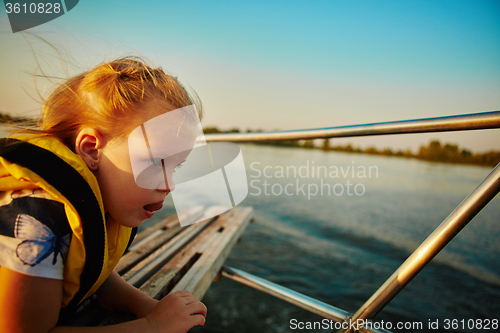 Image of Little girl enjoying ride on yacht