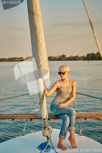 Image of Pretty young female tourist makes selfie on yacht