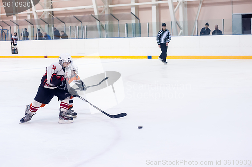 Image of Children play ice-hockey