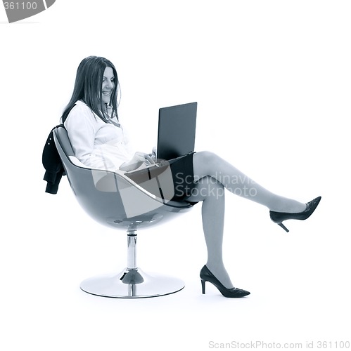 Image of monochrome businesswoman with laptop in chair