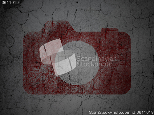 Image of Travel concept: Photo Camera on grunge wall background