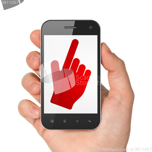 Image of Web development concept: Hand Holding Smartphone with Mouse Cursor on display