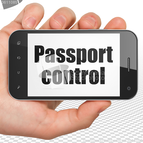 Image of Vacation concept: Hand Holding Smartphone with Passport Control on display