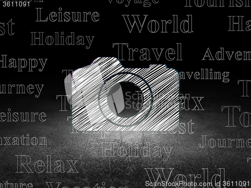 Image of Travel concept: Photo Camera in grunge dark room