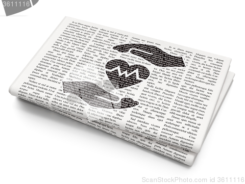 Image of Insurance concept: Heart And Palm on Newspaper background