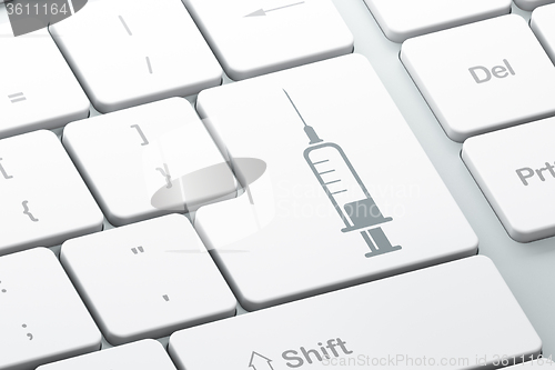 Image of Healthcare concept: Syringe on computer keyboard background