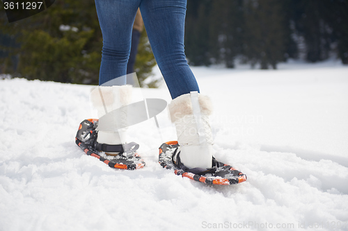 Image of couple having fun and walking in snow shoes