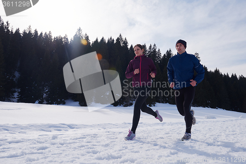 Image of couple jogging outside on snow