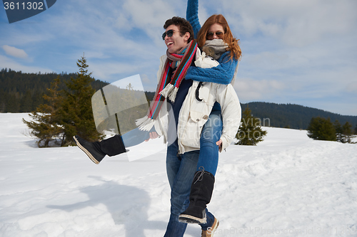 Image of happy young couple having fun on fresh show on winter vacation