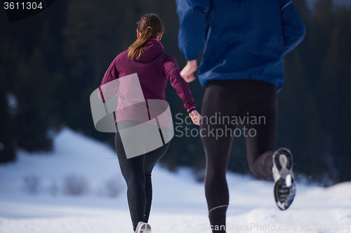 Image of couple jogging outside on snow