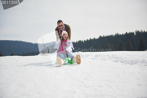 Image of happy young couple having fun on fresh show on winter vacation