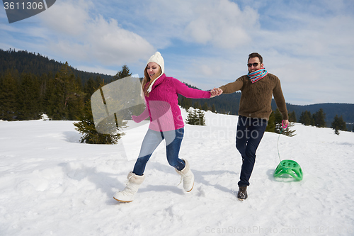 Image of happy young couple having fun on fresh show on winter vacation