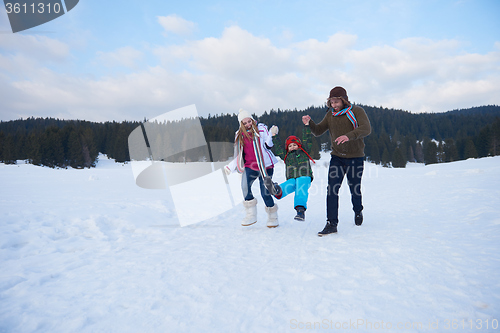 Image of happy family playing together in snow at winter