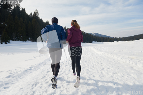 Image of couple jogging outside on snow