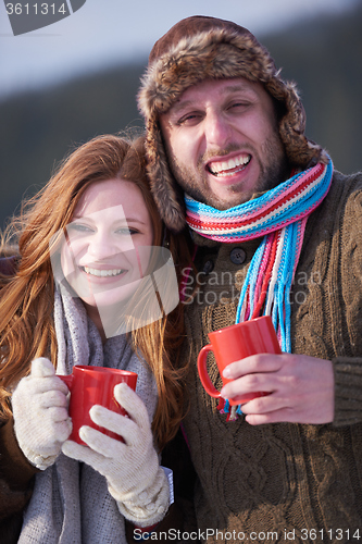 Image of couple drink warm tea at winter