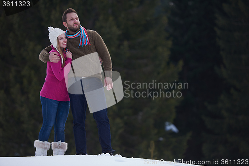 Image of couple having fun and walking in snow shoes