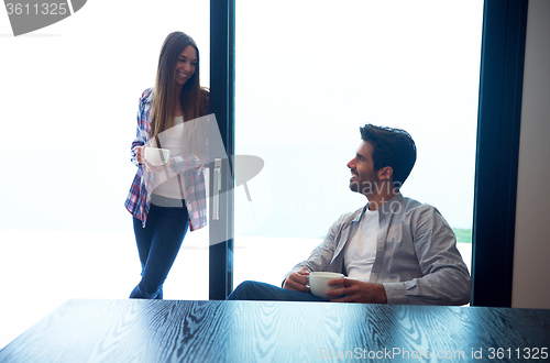 Image of relaxet young couple drink first morning coffee