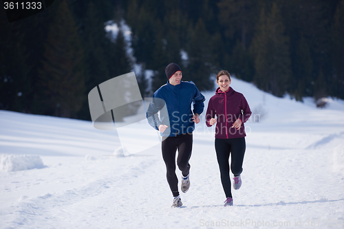 Image of couple jogging outside on snow