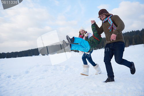 Image of happy family playing together in snow at winter