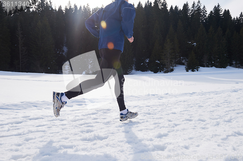 Image of jogging on snow in forest