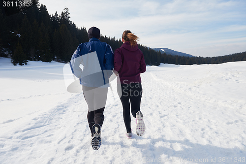 Image of couple jogging outside on snow