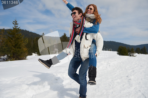 Image of happy young couple having fun on fresh show on winter vacation