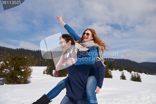 Image of happy young couple having fun on fresh show on winter vacation