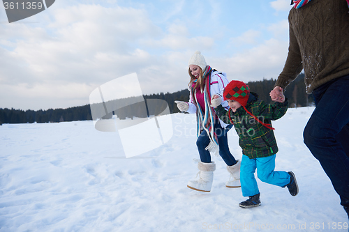 Image of happy family playing together in snow at winter