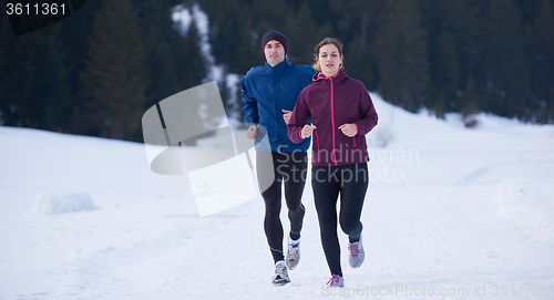 Image of couple jogging outside on snow