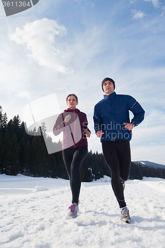 Image of couple jogging outside on snow