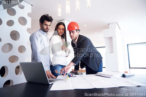 Image of couple buying new home with real estate agent