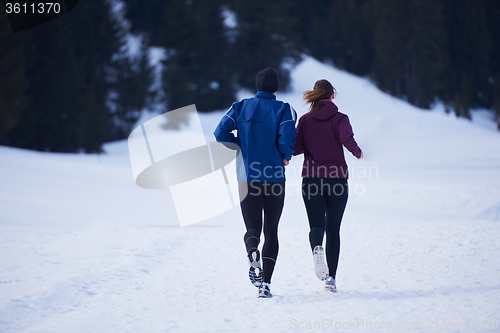 Image of couple jogging outside on snow