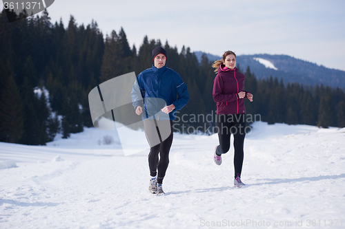 Image of couple jogging outside on snow