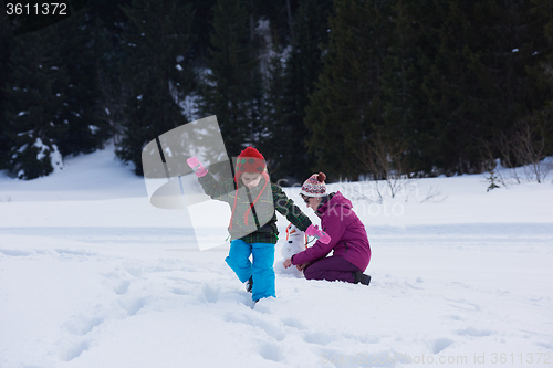 Image of happy family building snowman