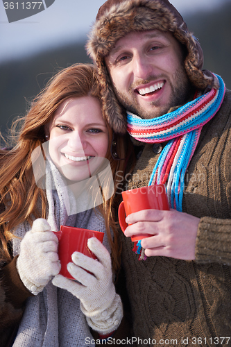 Image of couple drink warm tea at winter