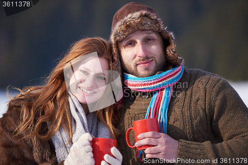 Image of couple drink warm tea at winter