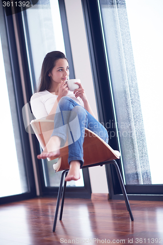 Image of beautiful young woman drink first morning coffee