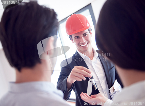 Image of couple buying new home with real estate agent