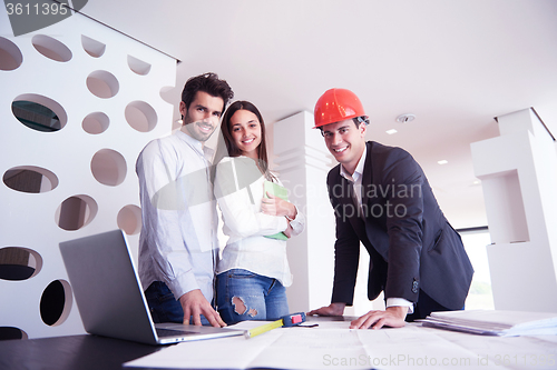 Image of couple buying new home with real estate agent