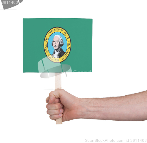 Image of Hand holding small card - Flag of Washington