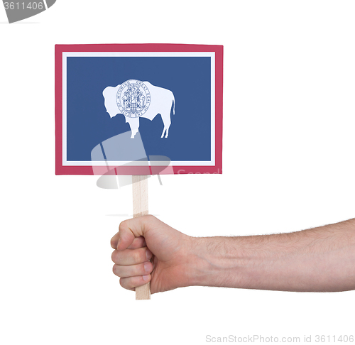 Image of Hand holding small card - Flag of Wyoming