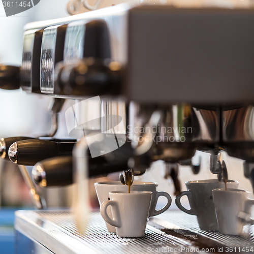 Image of Professional coffee machine making espresso.