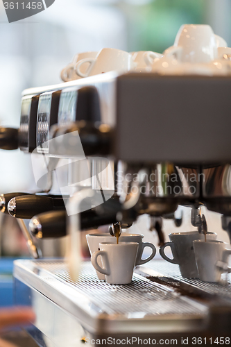 Image of Professional coffee machine making espresso.
