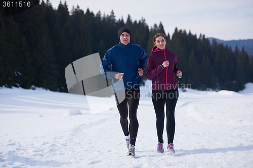 Image of couple jogging outside on snow