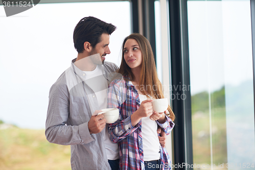 Image of relaxet young couple drink first morning coffee