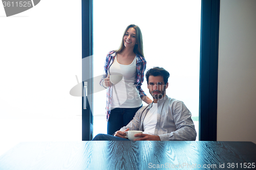 Image of relaxet young couple drink first morning coffee