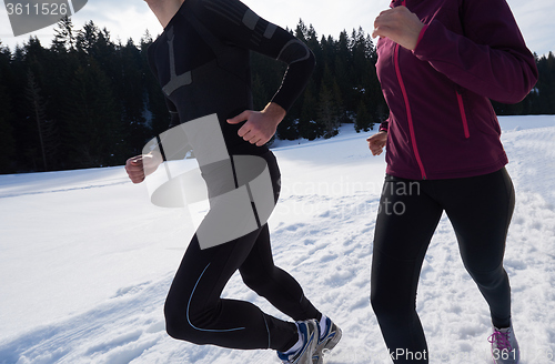 Image of couple jogging outside on snow