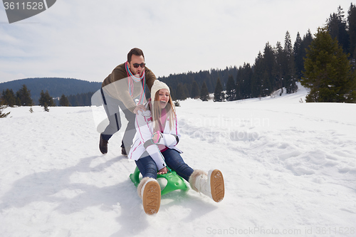 Image of happy young couple having fun on fresh show on winter vacation