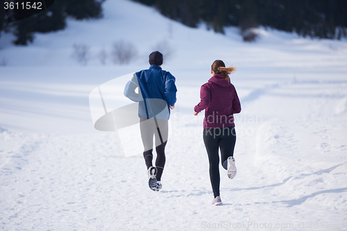 Image of couple jogging outside on snow