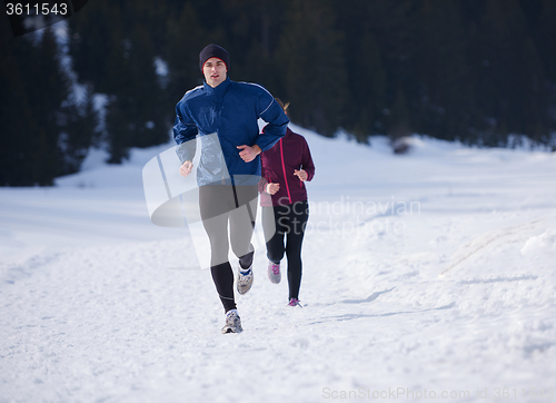 Image of couple jogging outside on snow